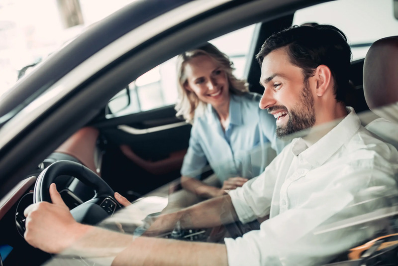 couple driving in new car